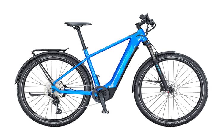 Blue KTM Macina Team LFC hardtail electric mountain bike with rear pannier rack on a white background.
