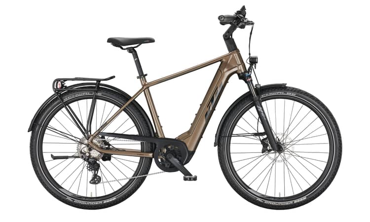 Modern brown Macina Gran 710 electric bicycle with black trim, fenders, and rear rack on white background.